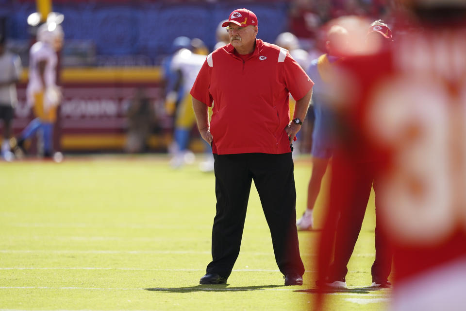 Kansas City Chiefs head coach Andy Reid watches as the teams warms-up before an NFL football game between the Kansas City Chiefs and the Los Angeles Chargers, Sunday, Sept. 26, 2021, in Kansas City, Mo. (AP Photo/Charlie Riedel)