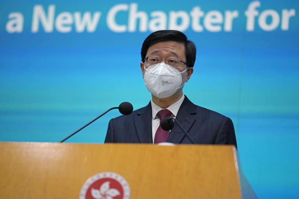 Hong Kong Chief Executive John Lee speaks during a news conference in Hong Kong, Tuesday, July 5, 2022. Lee said Tuesday in his first news conference since taking the reins that he will work towards legislating easing restrictions for travelers, but that it must be balanced with limiting the spread of the coronavirus so as not to overwhelm the healthcare system. (AP Photo/Kin Cheung)