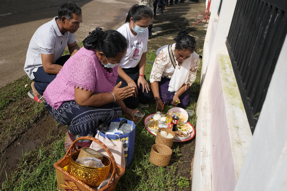 Relatives of the victim pray in front of former childcare center after the Buddhist ceremony in the rural town of Uthai Sawan, in Nong Bua Lamphu province, northeastern Thailand, Friday, Oct. 6, 2023. A memorial service takes place to remember those who were killed in a grisly gun and knife attack at a childcare center. A former police officer killed 36 children and teachers in the deadliest rampage in Thailand's history one year ago. (AP Photo/Sakchai Lalit)