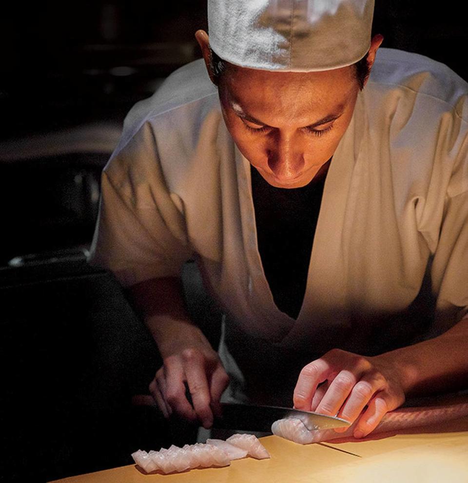 Chef Kevin Cory of Naoe, the only Miami restaurant to make the Forbes Five-Star list, slices fish.