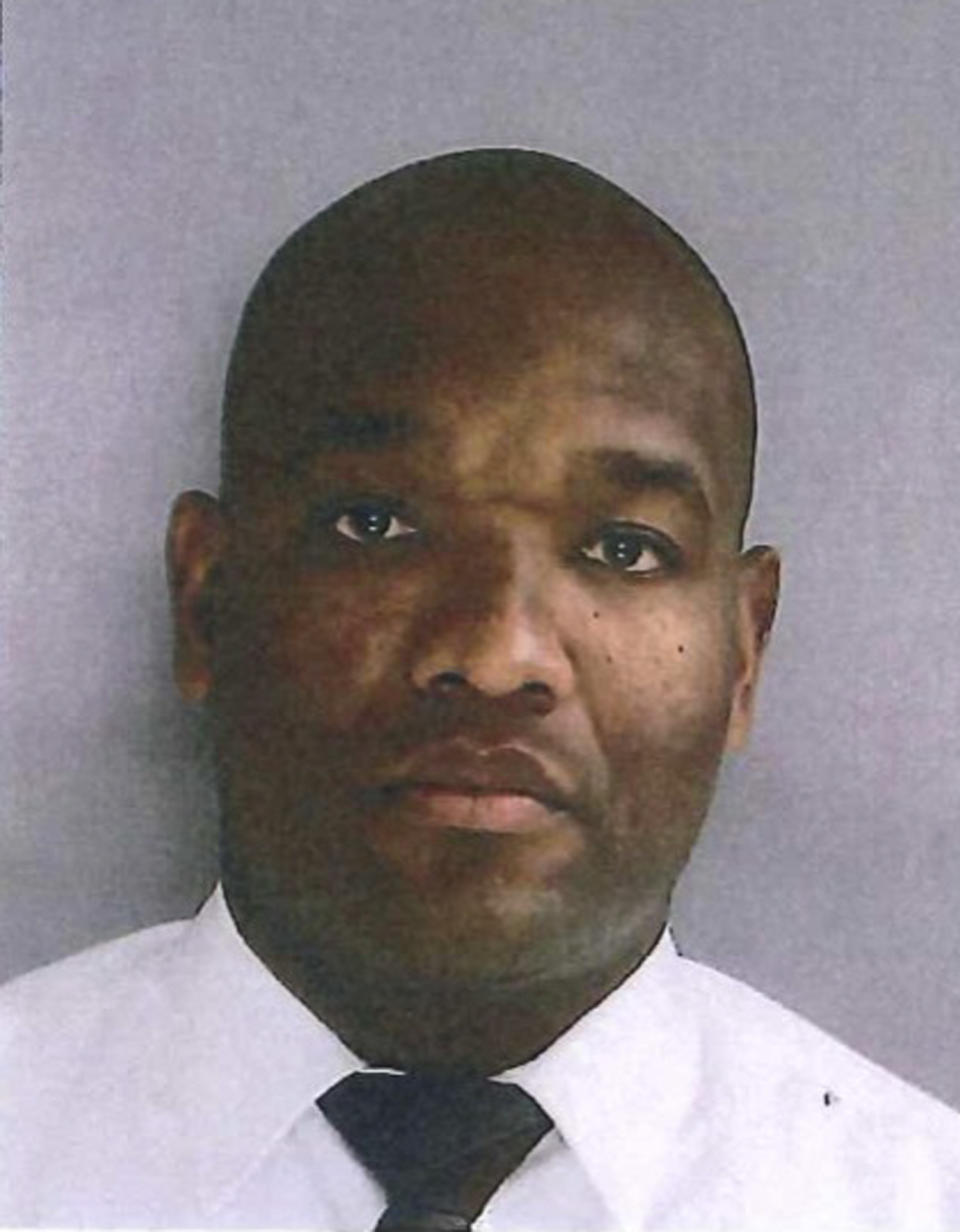 In this photo provided by the Delaware County District Attorney's Office on Tuesday, Jan. 18, 2022, shows Sharon Hill Police officer Devon Smith. Smith is one of three police officers that have been charged with manslaughter and reckless endangerment after firing their weapons into a crowd of people exiting a high school football game outside of Philadelphia, killing 8-year-old Fanta Bility and injuring three people. (Delaware County District Attorney's Office vis AP)