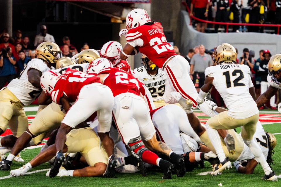 Sep 7, 2024; Lincoln, Nebraska, USA; Nebraska Cornhuskers running back Dante Dowdell (23) dives over the pile for a touchdown against the Colorado Buffaloes during the second quarter at Memorial Stadium. Mandatory Credit: Dylan Widger-Imagn Images