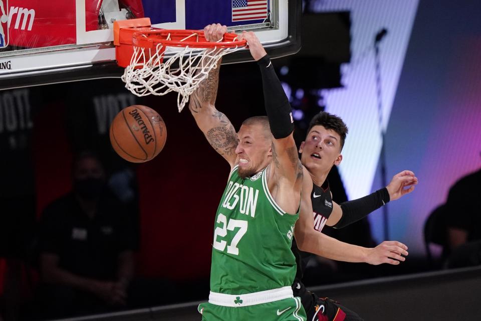 Boston Celtics center Daniel Theis (27) dunks the ball after gettin through Miami Heat's Tyler Herro, right, during the first half of Game 4 of an NBA basketball Eastern Conference final, Wednesday, Sept. 23, 2020, in Lake Buena Vista, Fla. (AP Photo/Mark J. Terrill)