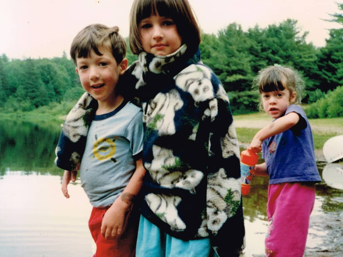 Danny Beale, one of the six workers killed in last January's Eastway Tank explosion in Ottawa, is seen here in a childhood photo with his two surviving siblings: older sister Meghan, centre, and his fraternal twin sister Jackie, right.  (Submitted by Meghan Beale - image credit)