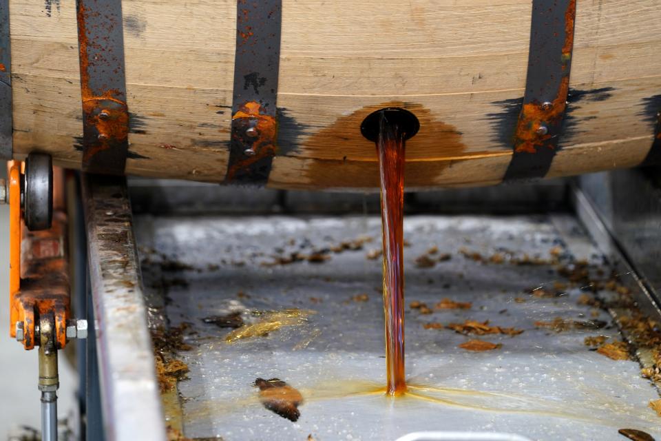 Bourbon is dumped to begin the filtration process before bottling, Tuesday, Oct. 3, 2023, at Boone County Distilling Company.