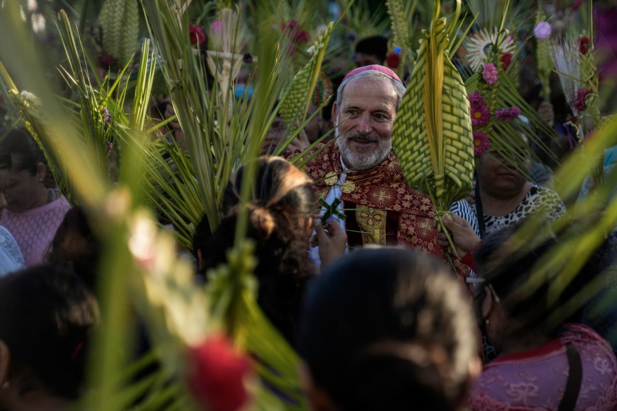 The bishop of Chilpancingo, José de Jesús González, participates in the Palm Sunday celebrations with fellow Catholics in his community. March 2024