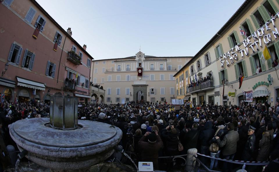 FILE - Pope Benedict XVI greets faithful from his summer residence of Castel Gandolfo, the scenic town where he spent his first post-Vatican days and made his last public blessing as pope, Feb. 28, 2013. Pope Emeritus Benedict XVI's death has hit Castel Gandolfo's "castellani" particularly hard, since many knew him personally, and in some ways had already bid him an emotional farewell when he uttered his final words as pope from the palace balcony overlooking the town square. (AP Photo/Andrew Medichini, File)