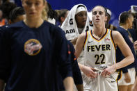 Indiana Fever guard Caitlin Clark (22) walks off the court with teammates after losing to the Connecticut Sun in a WNBA basketball game, Tuesday, May 14, 2024, in Uncasville, Conn. (AP Photo/Jessica Hill)