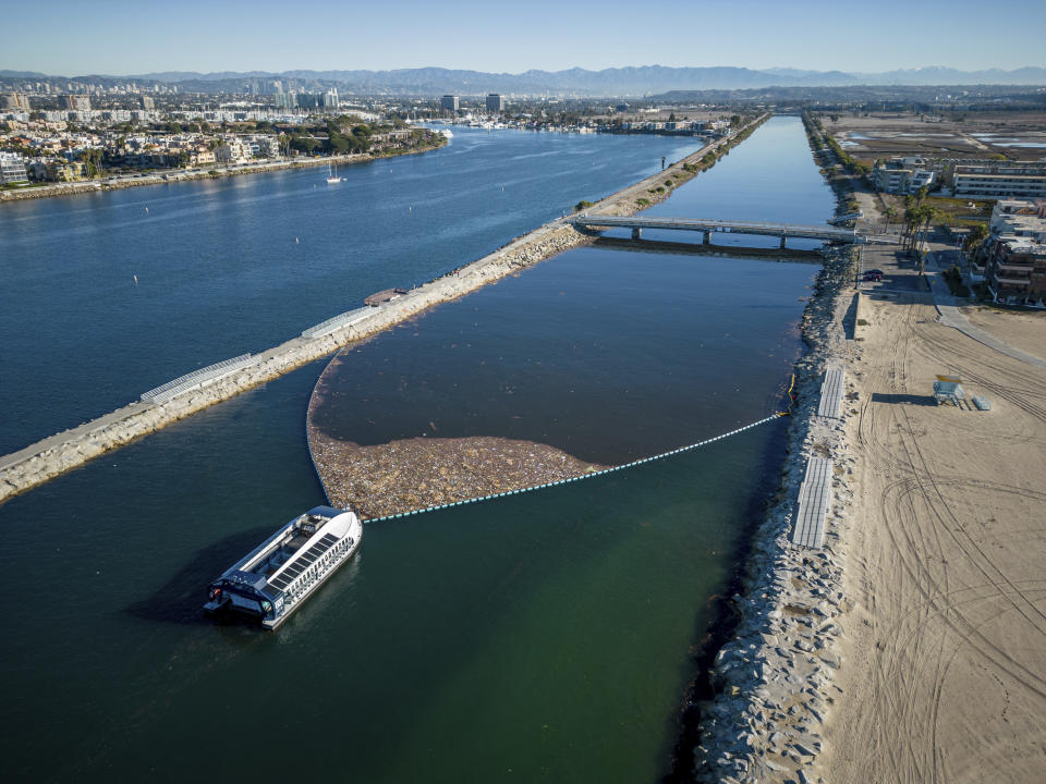 This photo provided by The Ocean Cleanup shows the Interceptor 007 collects trash in Ballona Creek, Calif., before it reaches the Pacific Ocean in 2022. (The Ocean Cleanup via AP)