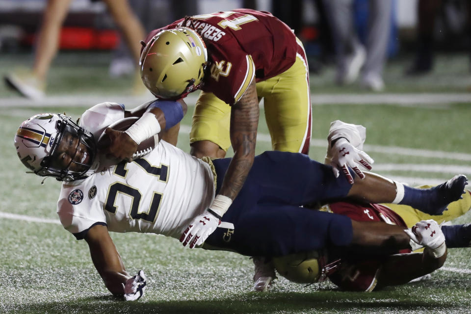 Boston College defensive back Brandon Sebastian (10) and defensive back Deon Jones, bottom right, tackle Georgia Tech running back Jordan Mason (27) during the second half of an NCAA college football game, Saturday, Oct. 24, 2020, in Boston. (AP Photo/Michael Dwyer)