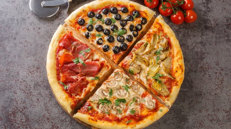 sliced pizza with four different toppings