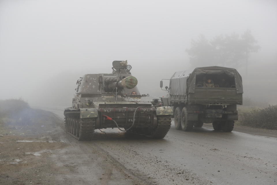 An Armenian self-propelled artillery unit rolls on a road during the withdrawal of Armenian troops from the separatist region of Nagorno-Karabakh, Wednesday, Nov. 18, 2020. A Russia-brokered cease-fire to halt six weeks of fighting over Nagorno-Karabakh stipulated that Armenia turn over control of some areas it holds outside the separatist territory's borders to Azerbaijan. Armenians are forced to leave their homes before the region is handed over to control by Azerbaijani forces. (AP Photo/Sergei Grits)