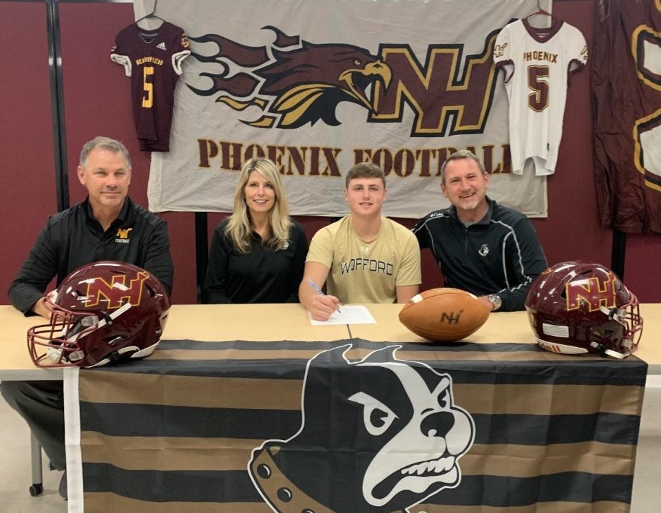 Pauly Seeley of New Hampstead with his parents and coach Kyle Hockman as he signed to play at Wofford College on Wednesday.