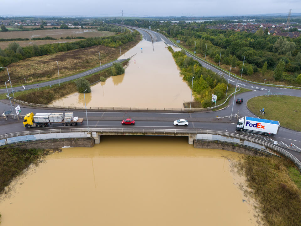 MARSTON MORETAINE, ENGLAND - SEPTEMBER 24: An aerial view as traffic passes along a road bridge over the flooded A421 dual carriageway on September 24, 2024 in Marston Moretaine, England. There was widespread travel disruption and damage to properties after Monday's heavy rains and flash flooding. (Photo by Carl Court/Getty Images)