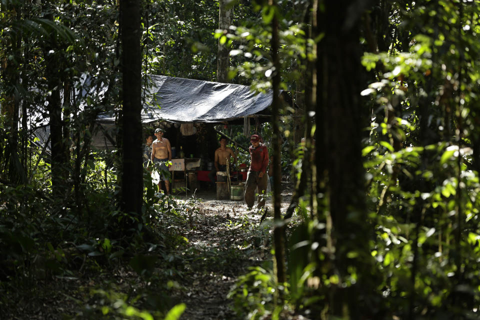 Illegal loggers stand in their camp as Tenetehara Indigenous men from the Ka'Azar, or Forest Owners, approach them and surround them on their lands on the Alto Rio Guama reserve in Para state, near the city of Paragominas, Brazil, Tuesday, Sept. 8, 2020. Three Tenetehara Indigenous villages are patrolling to guard against illegal logging, gold mining, ranching, and farming on their lands, as increasing encroachment and lax government enforcement during COVID-19 have forced the tribe to take matters into their own hands. (AP Photo/Eraldo Peres)