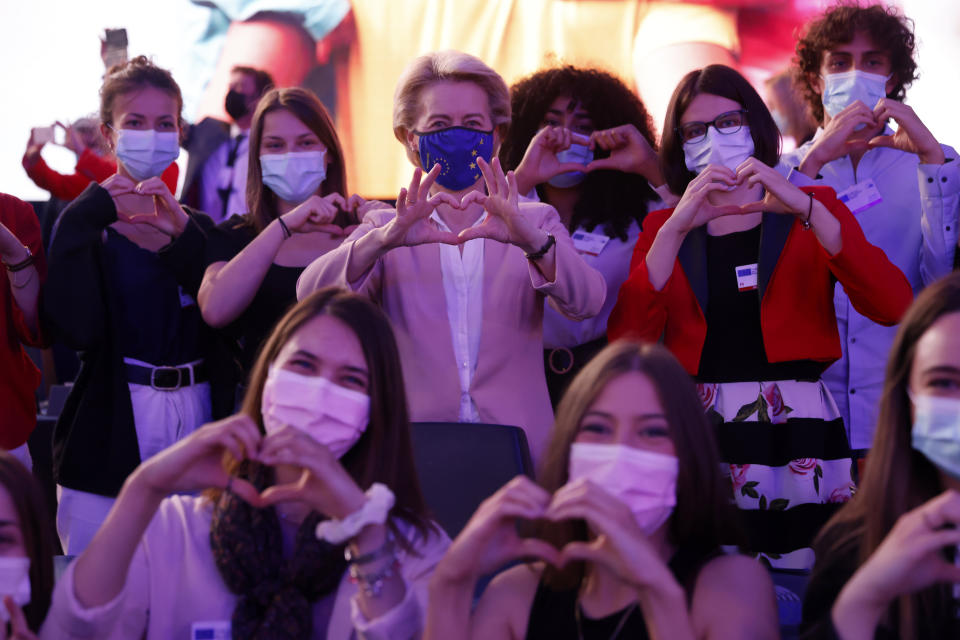 European Commission President Ursula von der Leyen makes a heart Erasmus European program students during Europe Day ceremony and the Future of Europe conference at the European Parliament in Strasbourg, eastern France, Sunday, May 9, 2021. (AP Photo/Jean-Francois Badias, Pool)