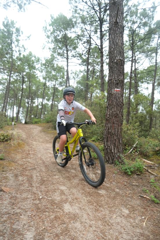 Freddie Tarr on a mountain bike while using a Koalaa tool to hold the handlebars 