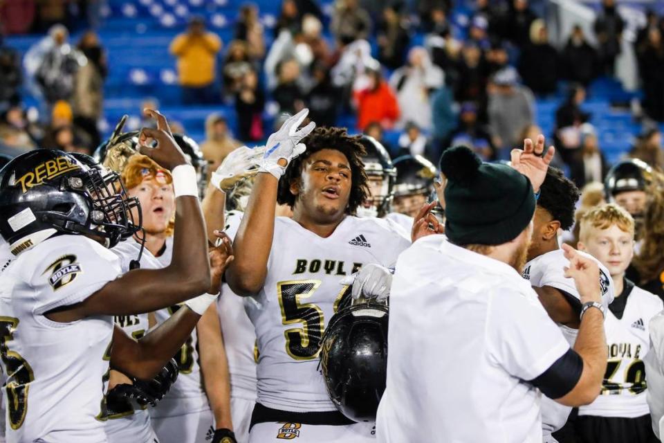 Boyle County’s Tommy Ziesmer (56) and his teammates celebrate the Rebels’ 32-26 three-peat win over Corbin in Class 4A state championship game at Kroger Field in Lexington on Friday night.