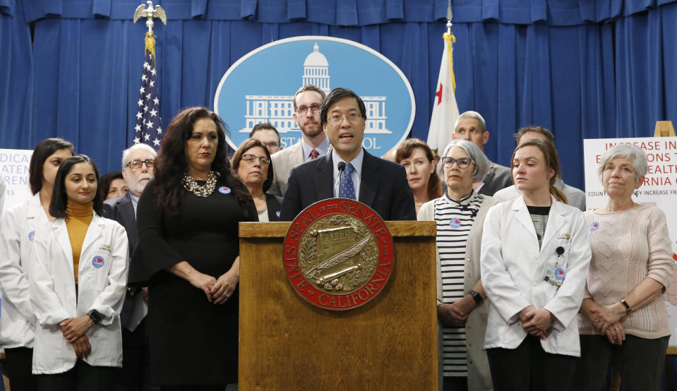 State Sen. Richard Pan, D-Sacramento, center, discusses his proposed measure to have public health officials grant medical exemptions for vaccination instead of leaving the power to physicians, during a news conference, Tuesday, March 26, 2019, in Sacramento, Calif. Pan, accompanied by co-author Assemblywoman Lorena Gonzalez, D-San Diego, fourth from left, say the legislation is needed to crack down on a few unscrupulous doctors who are helping parents avoid vaccinating their children. Opponents say the move is unnecessary because current law has already increased the vaccination rate.(AP Photo/Rich Pedroncelli)