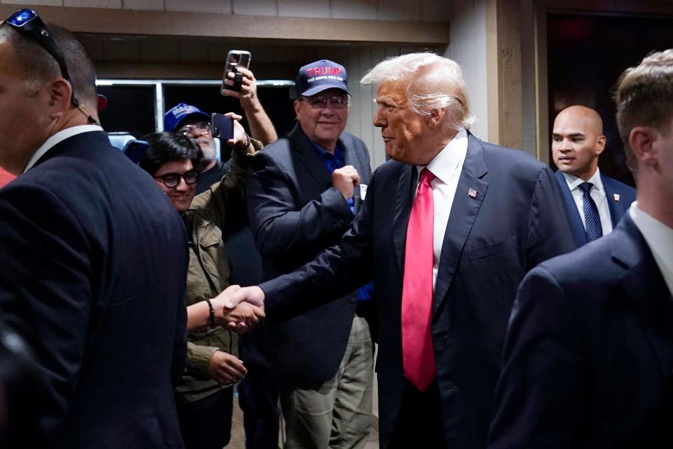 Former President Donald Trump greets supporters before speaking at the Westside Conservative Breakfast, Thursday, June 1, 2023, in Des Moines, Iowa. (AP Photo/Charlie Neibergall)