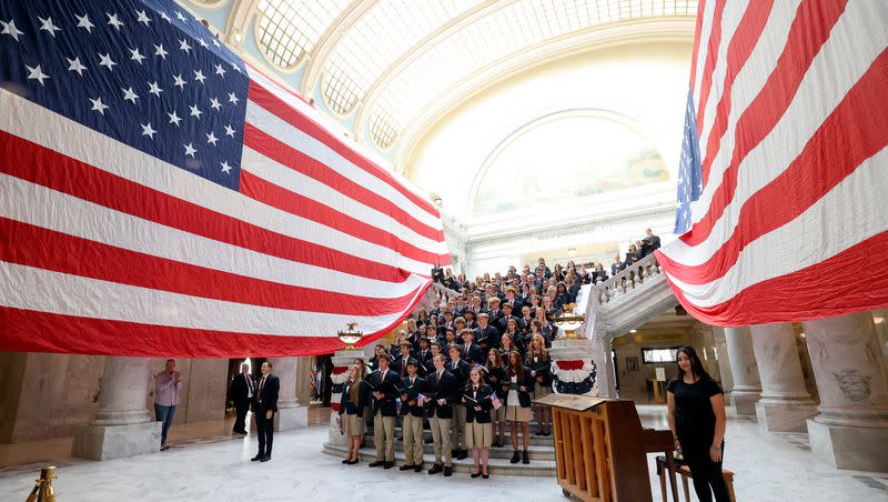 The American Heritage School choir stands between two giant American flags during the Constitution Month kickoff event at the Capitol in Salt Lake City on Thursday, Aug. 31, 2023. Civics education helps the next generation understand the values of the Constitution.