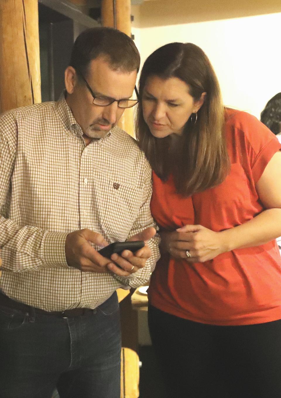 Republican Megan Dahle, right, checks early election results with husband, state Sen. Brian Dahle, on Tuesday night, Aug. 27, 2019, at her election watch party in Redding. Megan Dahle, of Bieber, is seeking to win the Assembly District 1 seat that was vacated when her husband was elected to the California Senate.