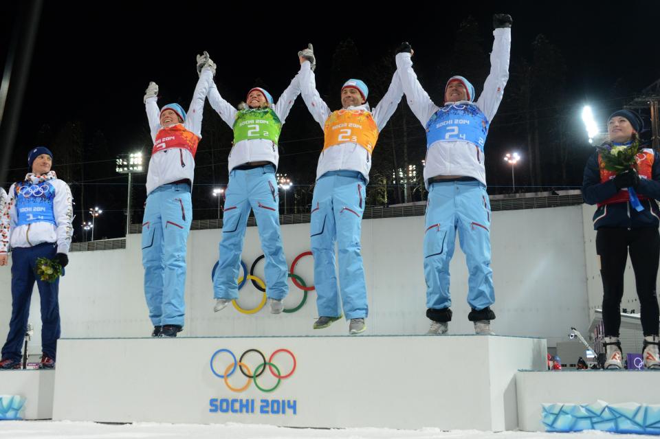 From left to right: Norway's Tora Berger, Tiril Eckhoff, Ole Einar Bjoerndalen and Norway's Emil Hegle Svendsen celebrate winning gold in the Biathlon mixed 2x6 km + 2x7,5 km Relay at the Laura Cross-Country Ski and Biathlon Center during the Sochi Winter Olympics on February 19, 2014 in Rosa Khutor near Sochi.   AFP PHOTO / KIRILL KUDRYAVTSEV        (Photo credit should read KIRILL KUDRYAVTSEV/AFP/Getty Images)