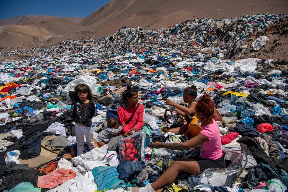 Women search for clothing items in the Atacama Desert.