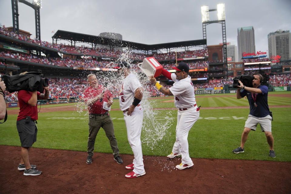 St. Louis Cardinals' Albert Pujols (5) is congratulated by teammate Yadier Molina (4) following a baseball game against the Chicago Cubs Sunday, Sept. 4, 2022, in St. Louis. Pujols hit a two-run home run in the eighth inning to lead the Cardinals to a 2-0 victory. (AP Photo/Jeff Roberson)
