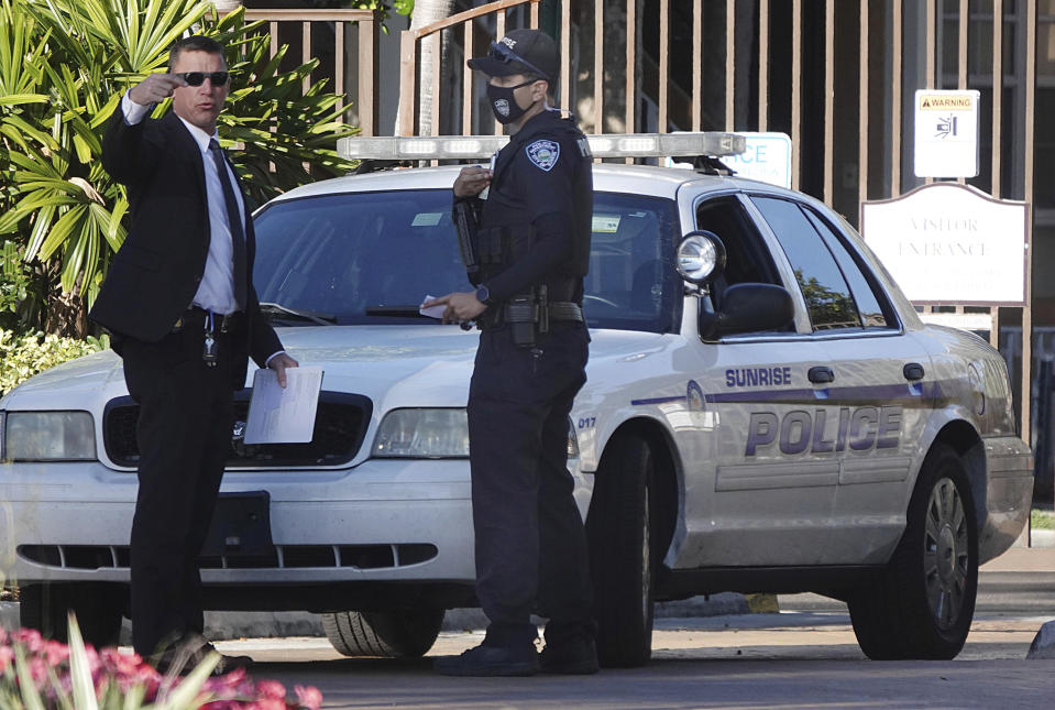 Law enforcement personnel continue to work at an apartment complex the day after a deadly shooting in Sunrise, Fla., Wednesday, Feb. 3, 2021. Several FBI agents were killed and others wounded while trying to serve a search warrant on a child pornography suspect in Florida. FBI authorities say the suspect also died. (Joe Cavaretta/South Florida Sun-Sentinel via AP)