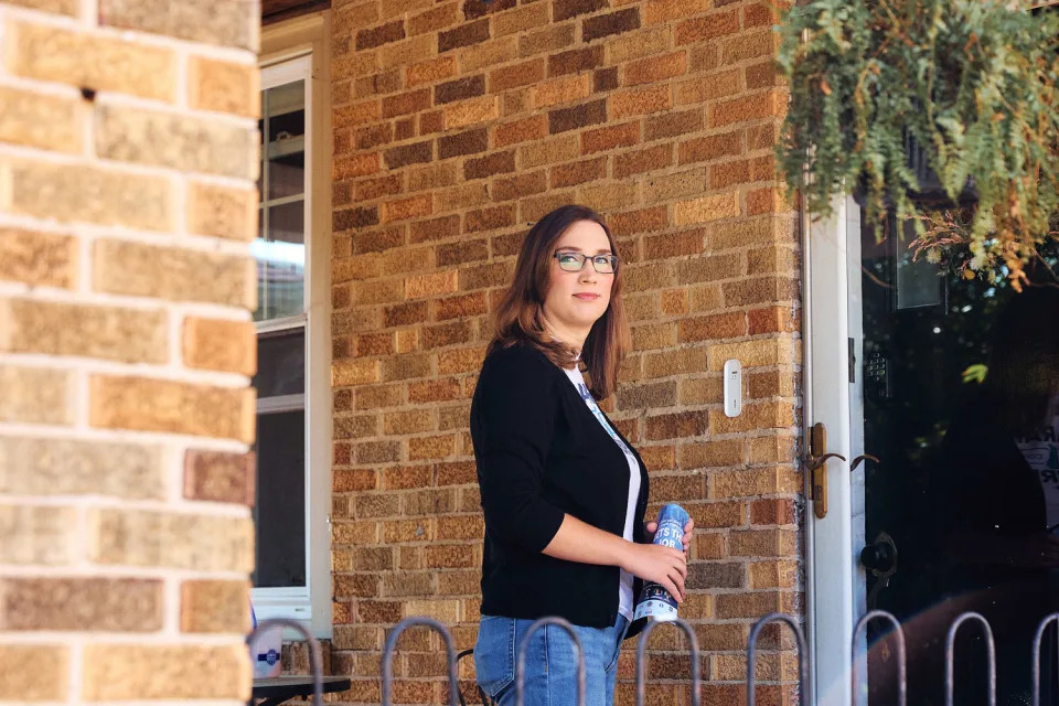  Sarah McBride with campaign literature at the door of a Wilmington home on Sept. 9. (Jana Williams for NBC News)