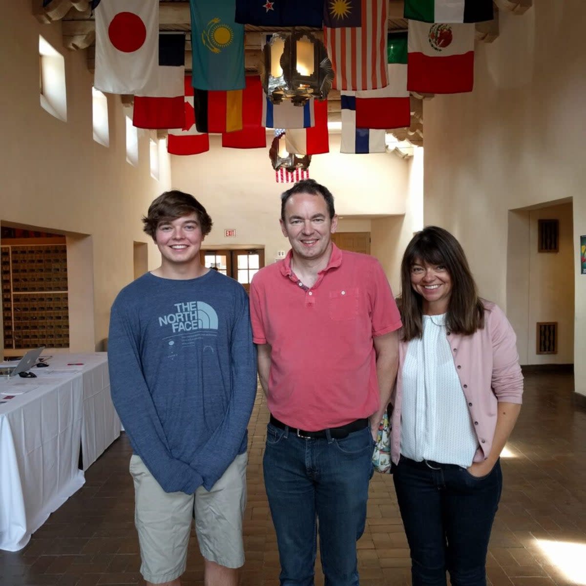 Christian Glass smiles with his parents, Sally and Simon Glass (The Glass Family)