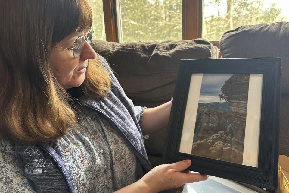 Barbara Roma, the mother of Chris Roma who died hiking, looks at family photos of her son at her home in Thornton, N.H., in the heart of the White Mountains, Friday, Jan. 19, 2024. Chris Roma, the expert hiker who completed the "Triple Crown" of challenging cross-country trails was found dead on Mount Guyot during a hike in brutal weather conditions. (AP Photo/Nick Perry)