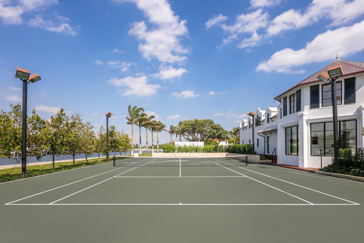 Lighted for night play, Tarpon Island's waterfront tennis court is on the west side of the Palm Beach estate, overlooked by the tennis pavilion at the right.