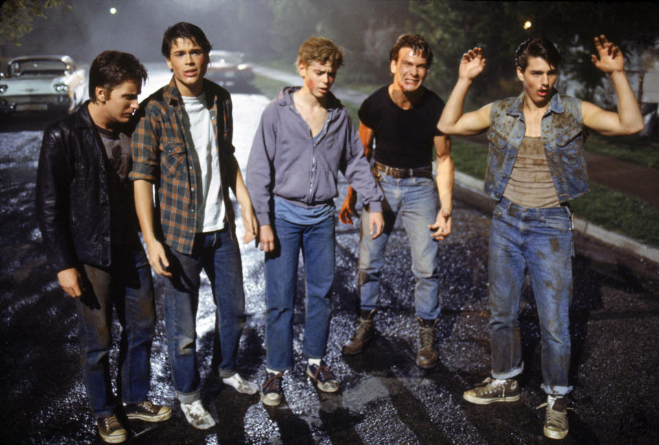 American actors Emilio Estevez, Rob Lowe, Thomas C. Howell, Patrick Swayze, and Tom Cruise on the set of The Outsiders, directed by Francis Ford Coppola. (Photo by Sunset Boulevard/Corbis via Getty Images)