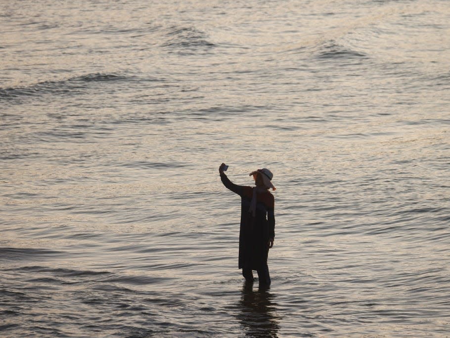 Woman standing alone in the sea