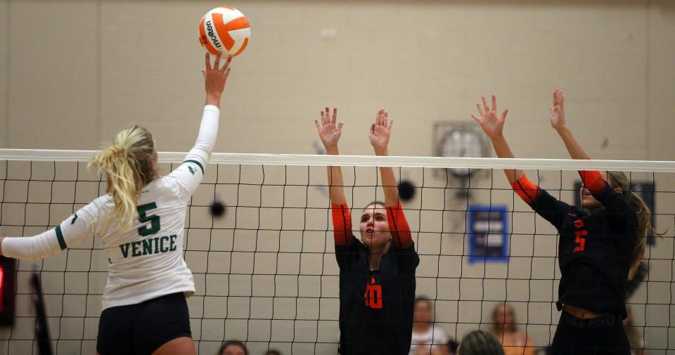 Venice High's Charley Goberville tries to hit past the Sarasota High block in a volleyball match Tuesday night at Eddie Howell Gymnasium in Sarasota.