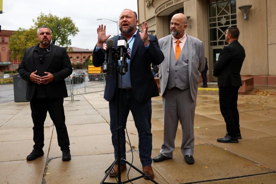 Alex Jones fumes at a press conference outside the Sandy Hook trial on 4 October (REUTERS)