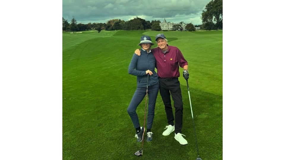 couple posing on golf course