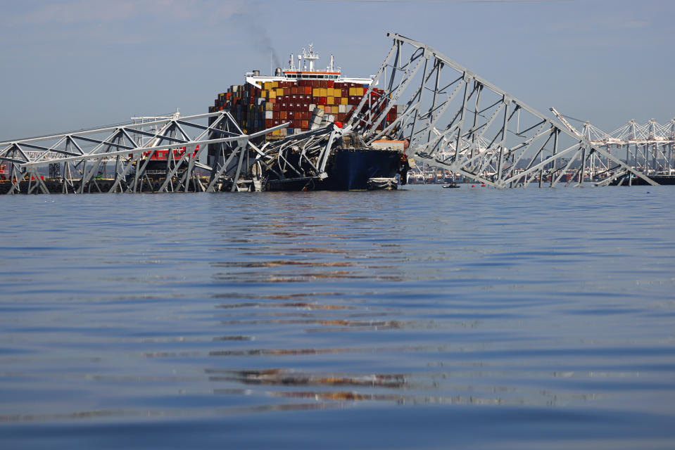 The collapsed Francis Scott Key Bridge lays on top of the container ship Dali, Monday, April 15, 2024, in Baltimore. The FBI confirmed that agents were aboard the Dali conducting court-authorized law enforcement activity. (AP Photo/Julia Nikhinson)
