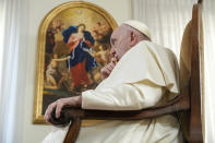 Pope Francis speaks during an interview with The Associated Press at The Vatican, Tuesday, Jan. 24, 2023. Pope Francis said there's a risk that what could be a trailblazing reform process in the German church could become "ideological." In the background a replica of German baroque painter Johann Georg Melchior Schmidtner's oil on canvas, "Mary untier of knots". (AP Photo/Andrew Medichini)