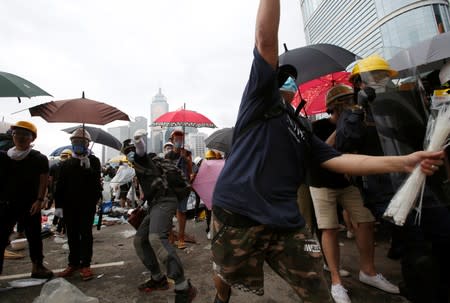 Protesters wearing masks and holding umbrellas take part in a demonstration against a proposed extradition bill, in Hong Kong