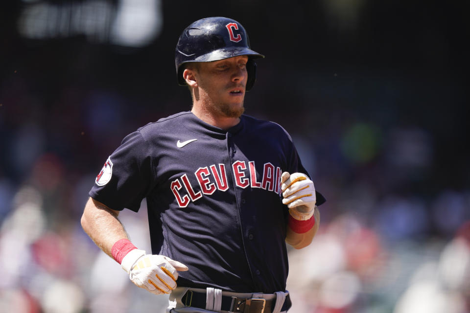 Cleveland Guardians' Myles Straw attempts to run to first after grounding out to Los Angeles Angels starting pitcher Kenny Rosenberg who threw to first baseman Mike Moustakas during the first inning of a baseball game, Sunday, Sept. 10, 2023, in Anaheim, Calif. (AP Photo/Ryan Sun)