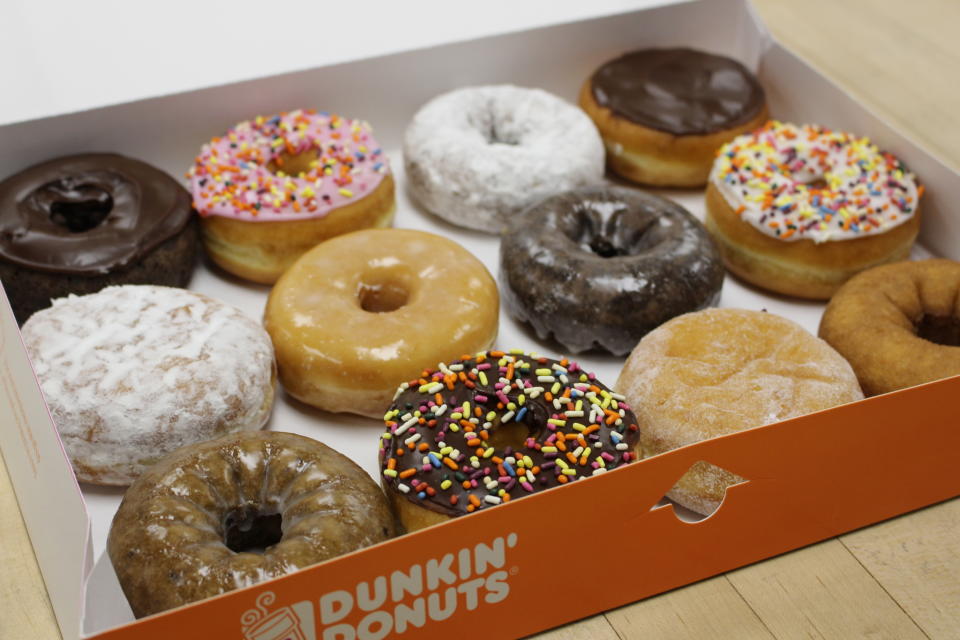 A box of a dozen assorted Dunkin' Donuts doughnuts.