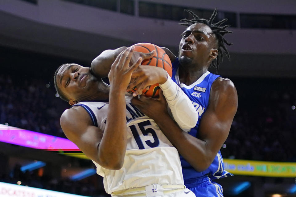 Creighton's Arthur Kaluma, right, and Villanova's Jordan Longino struggle for a rebound during the second half of an NCAA college basketball game, Saturday, Feb. 25, 2023, in Philadelphia. (AP Photo/Matt Slocum)