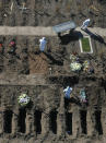 FILE - In this July 25, 2020 file photo, cemetery workers prepare graves at the Flores cemetery where people who died from the coronavirus are being buried in Buenos Aires, Argentina. People are on edge in Argentina, where the number of new coronavirus cases is surging despite nearly five months of strict limits on movement and activities in Buenos Aires and the surrounding area. (AP Photo/Gustavo Garello, File)