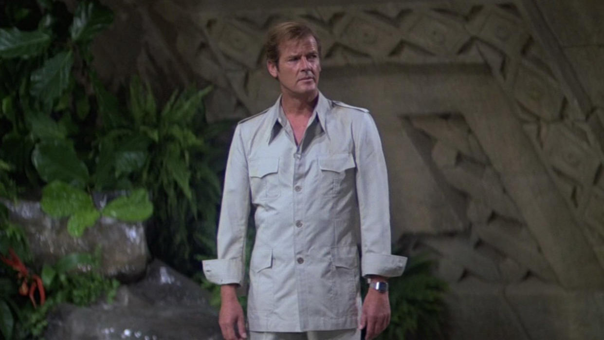  Roger Moore's James Bond looks confused as he stands in a giant room. 