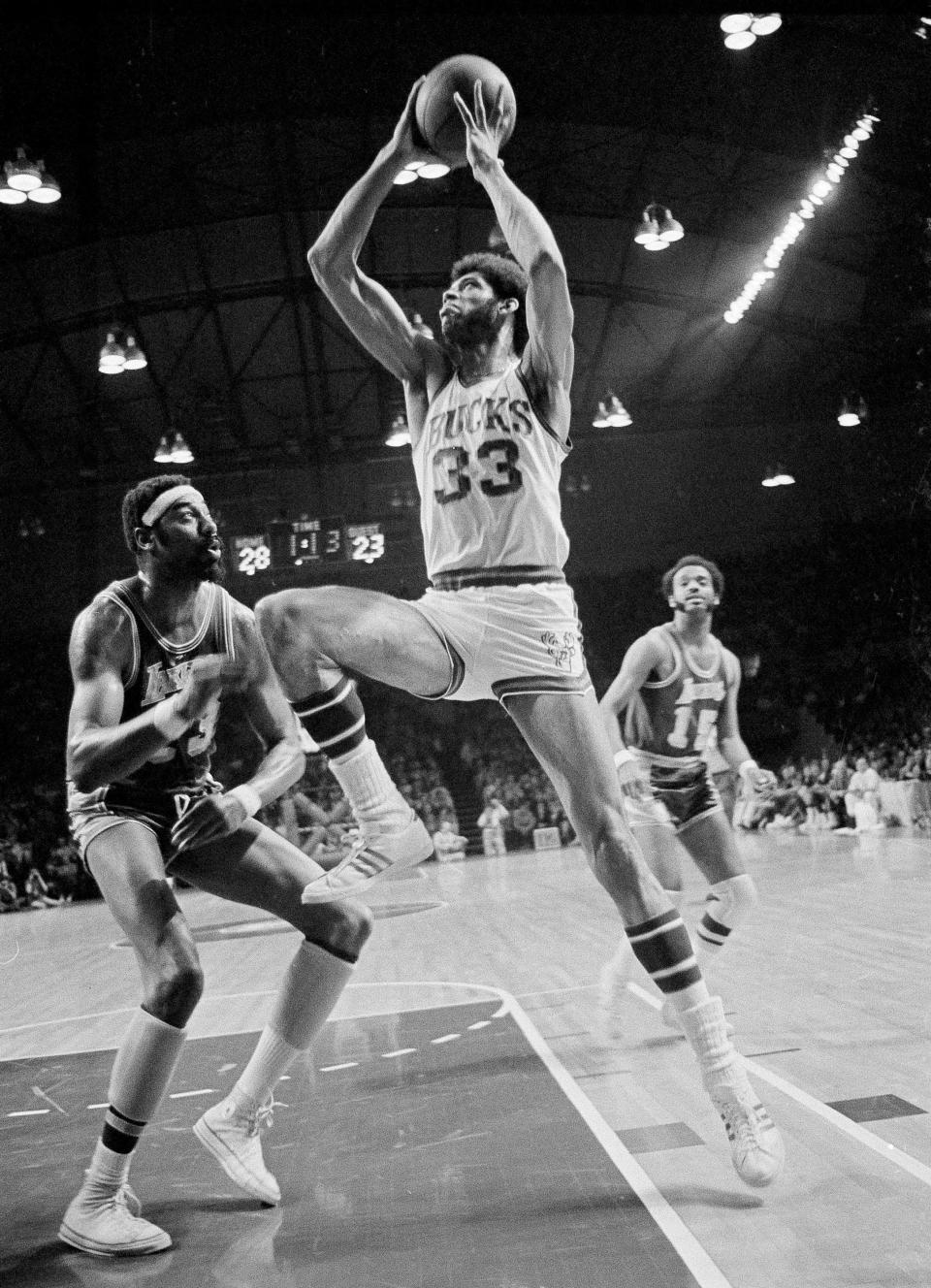 Milwaukee Bucks star Lew Alcindor (33) stretches his long frame as he drives past the Los Angeles Lakers' Wilt Chamberlain during the 1971 NBA playoffs at Milwaukee. Alcindor changed his name legally to Kareem Abdul-Jabbar heading into the 1971-72 season.