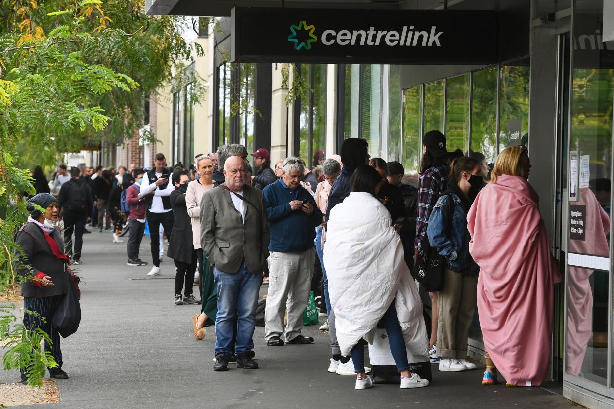 Hundreds of people queue outside an Australian government welfare centre, Centrelink, in Melbourne on March 23, 2020, as jobless Australians flooded unemployment offices around the country after Prime Minister Scott Morrison warned the coronavirus pandemic would cause an economic crisis akin to the Great Depression. - In scenes not seen in Australia for decades, queues stretched around the block at unemployment offices around the country as the forced closure of pubs, casinos, churches and gyms began at midday on March 23. (Photo by William WEST / AFP) (Photo by WILLIAM WEST/AFP via Getty Images)