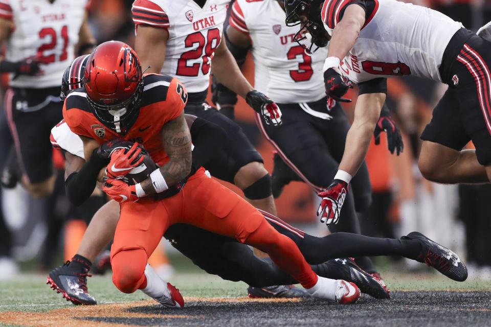 Oregon State receiver Anthony Gould is brought down by Utah cornerback Zemaiah Vaughn, Sept. 29, 2023, in Corvallis, Ore.